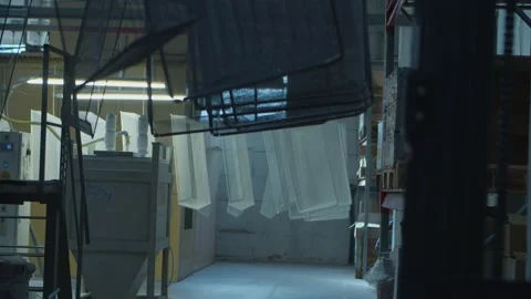 Dyed wired mesh cages moving on the track in the factory Stock Footage 153469510
