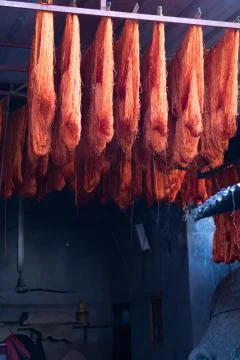 Dyed wool hanging to dry in souk in Marrakech Morocco, red, blue, yellow, gold Stock Photos