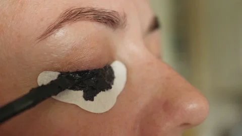 Dyeing eyelashes with henna apply applying with eye protection paper Stock Footage 134286848