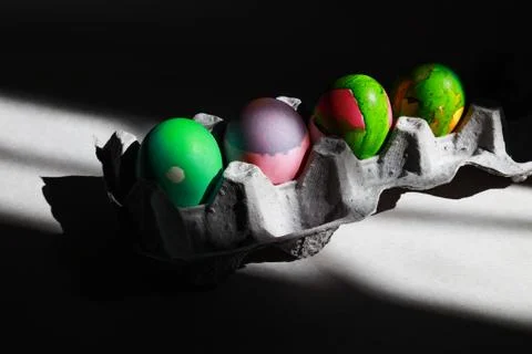 Dyi decorated easter eggs in a cart in hard light Stock Photos