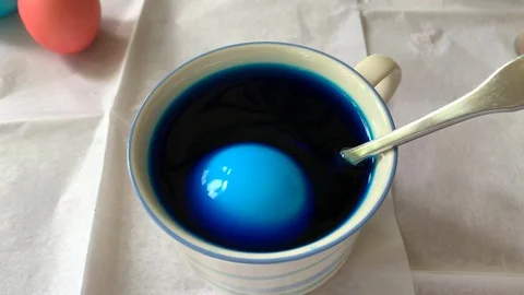 Dying a blue Easter egg Stock Footage 106766171