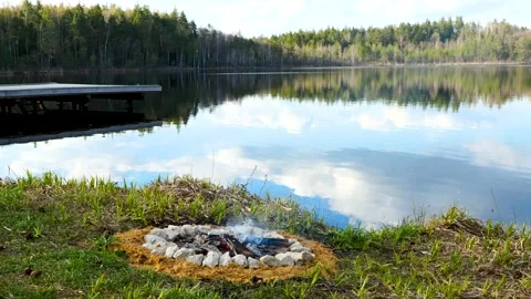 Dying Campfire by the Lake in the Forest Stock Footage 191028129
