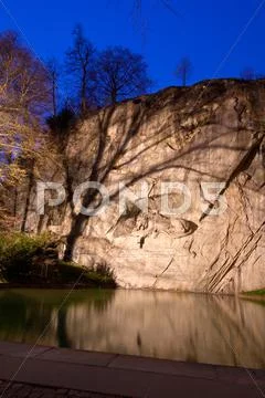 Dying lion monument in lucern switzerland twilight, vertical Stock Photos