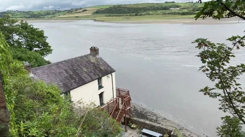 Dylan Thomas Boathouse on the estuary of the River Taf, Laugharne. Stock Footage 247265703