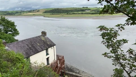 Dylan Thomas Boathouse on the estuary of the River Taf, Laugharne. Stock Footage 247265722