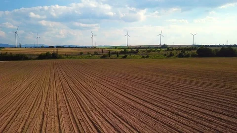 Dynamic 4k drone shot of  train passing in front of windgenerators Stock Footage 108590388