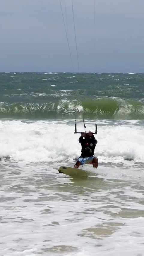 A dynamic action video showcasing a skilled kitesurfer riding choppy sea wa.. Stock Footage 337354310