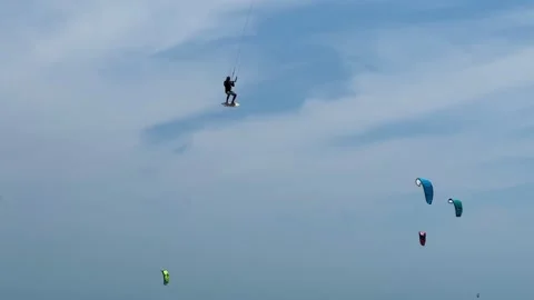 A dynamic action video showcasing a skilled kitesurfer riding choppy sea wa.. Stock Footage 337354320