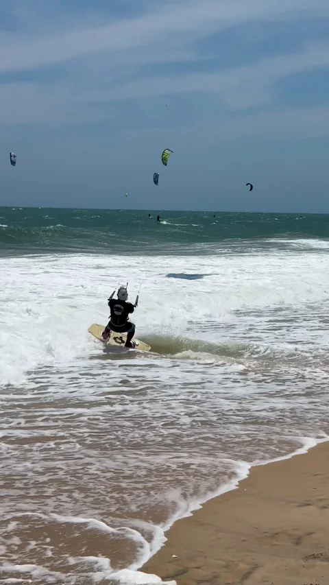 A dynamic action video showcasing a skilled kitesurfer riding choppy sea wa.. Stock Footage 337354326
