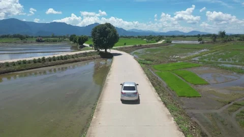 Dynamic Aerial Drone Chase of a Car Driving Through Picturesque Chiang Rai Stock-Footage 247688532