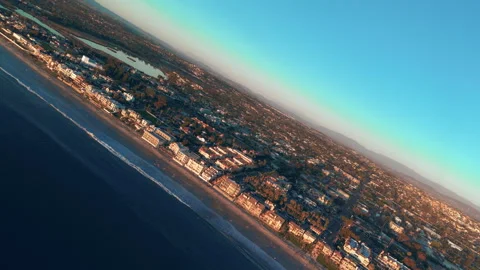 Dynamic aerial drone rotation over Carlsbad coastline showing beach city Vídeo Stock 332314112