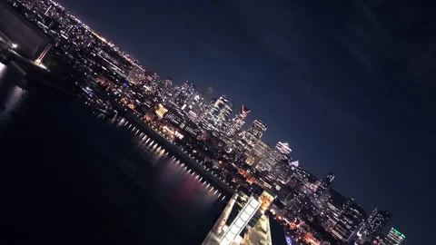 Dynamic Aerial Flight with Camera Roll Over Montreal Skyline at Night Stock Footage 318564722