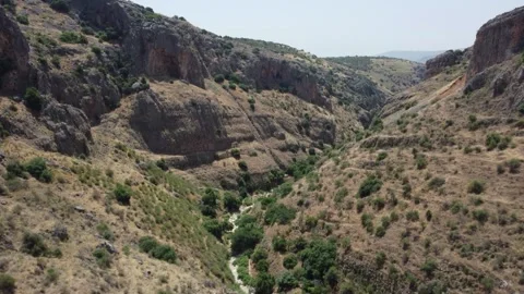 Dynamic aerial footage flying through a deep and rugged rock canyon. Stock Footage 154753630