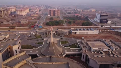 Dynamic aerial of a large symbol on top of the NILDS office building in Abuja Stock Footage 328852390