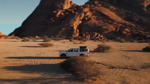 Dynamic aerial orbit of a 4x4 pickup truck equipped for adventure, driving 스톡 동영상 311100077