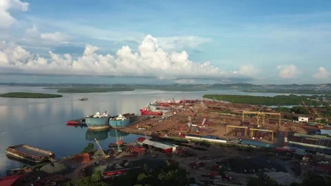 Dynamic aerial perspective of a sprawling coastal shipyard bustling with ma.. Stock Footage 337282431