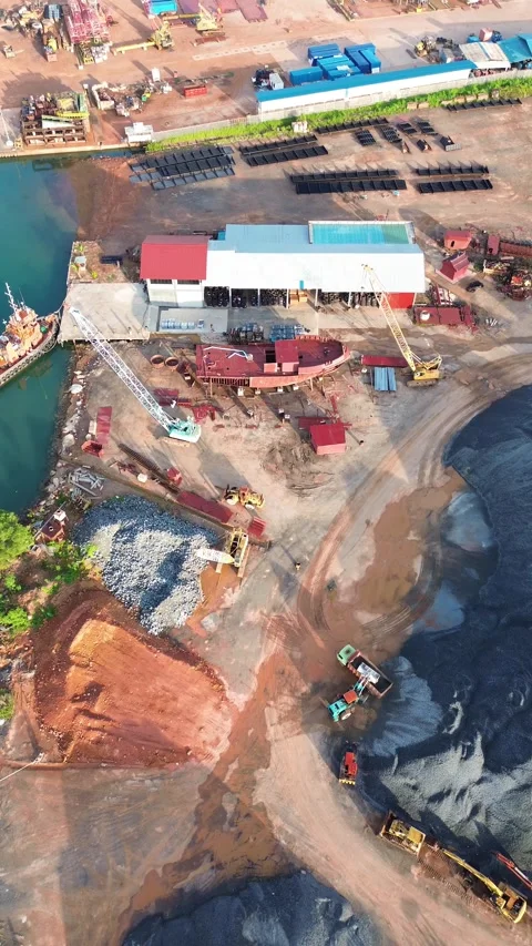 Dynamic Aerial Perspective of a Thriving Coastal Industrial Zone Featuring .. Stock Footage 337282518