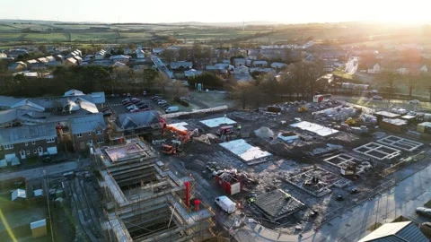 Dynamic Aerial Rotation of Construction Site with Scenic Background, UK Stock Footage 261696572