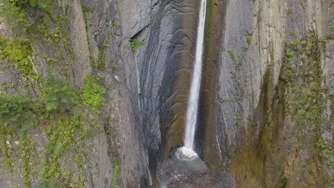Dynamic aerial shot moving from bottom to top over the lush green mountain ridge Stock Footage 303398497
