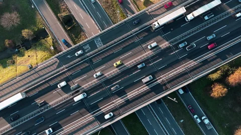 Dynamic Aerial View of Bustling Urban Highway Intersection on a Sunny Day Video stock 324936573