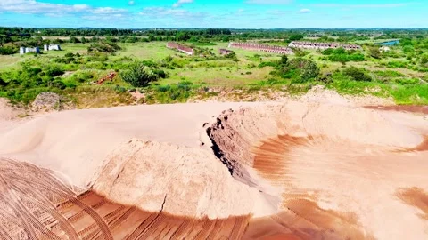 Dynamic Aerial view of a sand quarry with historic ruins in the background 库存影片 335685410