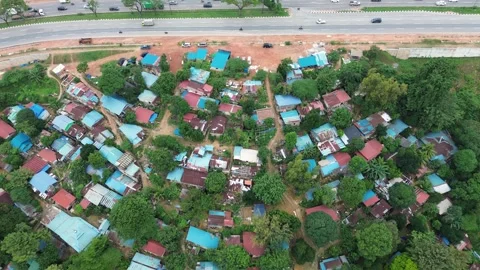 Dynamic aerial view showcasing a modern highway adjacent to a vibrant 動画素材 319458580