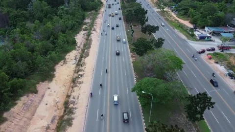 Dynamic aerial vista showcasing bustling traffic flow on a verdant highway .. Stock-Footage 339036719