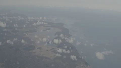 Dynamic anamorphic shot ocean sea coastline clouds helicopter airplane view Stock Footage 118859286
