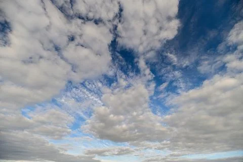 A Dynamic and Captivating Cloudscape Vividly Set Against a Bright Blue Sky Above Stock Photos