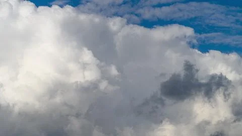 Dynamic and everchanging Cloud Patterns dancing gracefully Under a Clear blue Sk Stock Photos