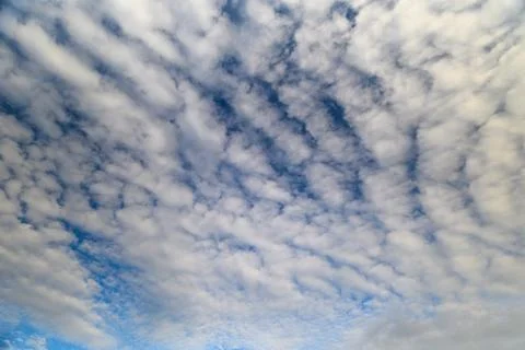 Dynamic and Intense Cloud Patterns Beautifully Stretching Across a Bright Blue S Stock Photos