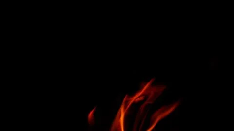 Dynamic and mesmerizing flames are dancing elegantly in the surrounding darkness 写真素材