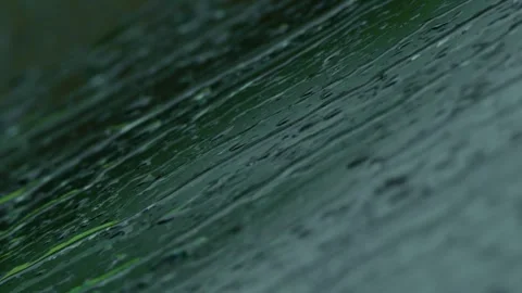 A dynamic and visually stunning closeup footage captures numerous raindrops Stock Footage 309335787
