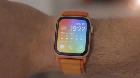 Dynamic Apple Watch with Vibrant Multicolor Background and Orange Strap, Stock Footage 247038118