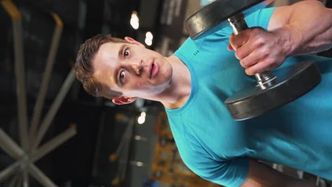 Dynamic Barrel Roll Shot of Athletic Man Lifting Weights At Gym | Slow Motion Stock Footage 167284984