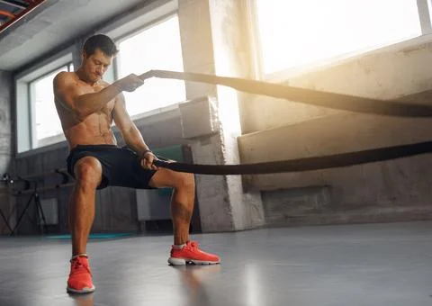 A Dynamic Battle Rope Workout boosts arm strength, core stability, and overall Stock Photos