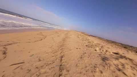 Dynamic beach view with ocean waves crashing on sandy shore Stock Footage 345058138