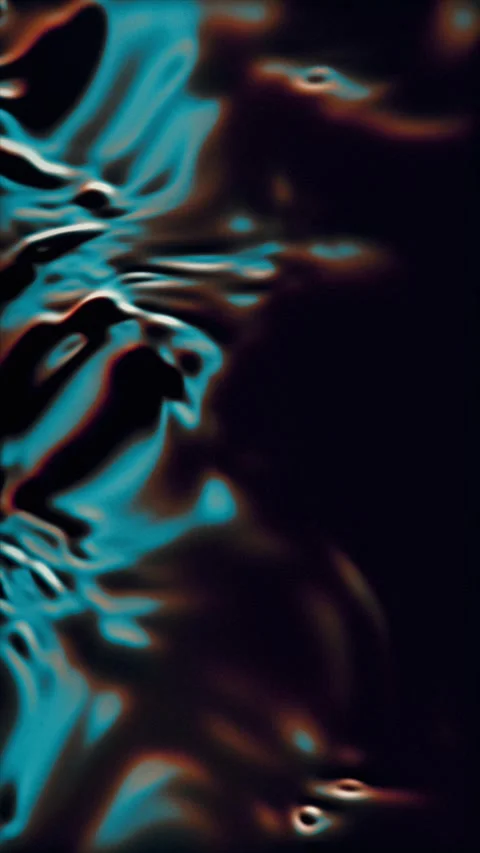 Dynamic blue and orange light ripples across a dark, flowing surface Video stock 331633100