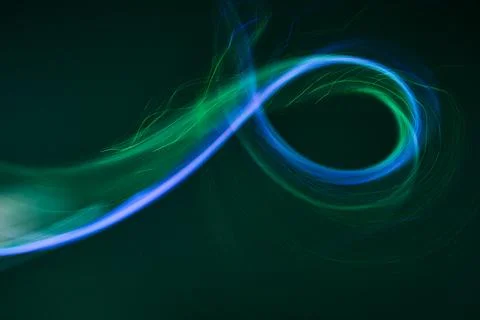 Dynamic blue green light trail swirling concept Stock Photos