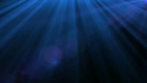Dynamic blue lens flare light beams radiating across dark background abstract Video stock 341322768