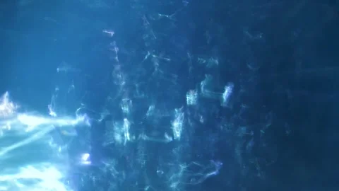 Dynamic blue light rays streaming through dark clouds. Abstract atmospheric ener Stock Footage 340456513