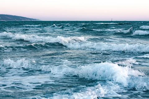​Dynamic Blue Ocean Waves at Twilight Stock Photos