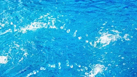 Dynamic blue water surface with sparkling ripples and bubbles moving across.. Stock-Footage 348288613