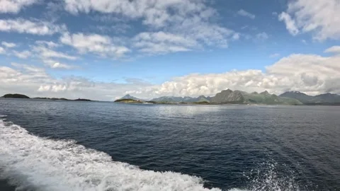 Dynamic boat wake with sea spray and mountain horizon Lofoten Stock-Footage 344047594