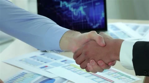 Dynamic business handshake in a sleek office environment Stock Footage 311933619