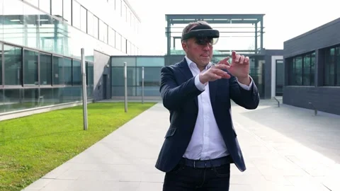 Dynamic Businessman Walking  Demonstrating VR Capabilities in Urban Setting Stock Footage 275860958
