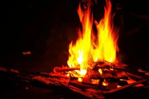 Dynamic Campfire with Bright Orange Flames and Glowing Red Embers on Burnin.. Stock Photos