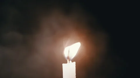 A Dynamic Candle Flame Beautifully Captured in a Dark Environment for Artistic Stock Footage 312014275