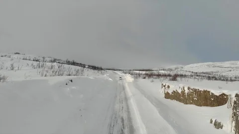 Dynamic car chase above icy road with snow in abisko, sweden Stock Footage 128809436