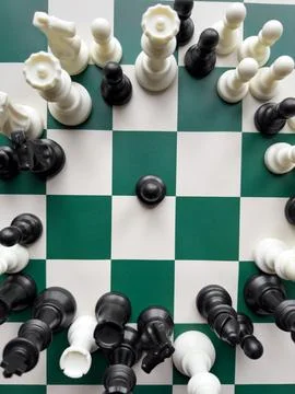 Dynamic chess game with vibrant black and white pieces on a checkered board Stock Photos